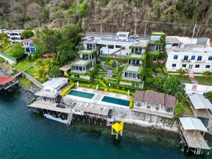 an aerial view of a house on the water at Cardedeu Residence Lago de Coatepeque in El Congo