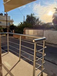 a metal railing on the side of a street at LIV Aspropyrgos in Asprópirgos