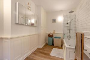a white bathroom with a sink and a shower at Character cottage with garden - Central Buxton in Buxton +12 photos