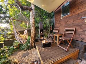 a hammock and a table and chairs on a deck at Character cottage with garden - Central Buxton in Buxton