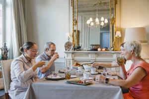 a group of people sitting at a table eating food at Nova Zembla in Mechelen