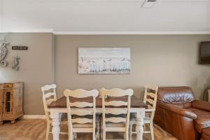 a dining room table with chairs and a couch at Blue Tide #8A in Seacrest