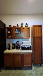 a kitchen with wooden cabinets and a counter top at Sitio Serra e Mar in Saquarema