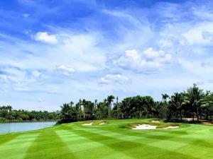 a golf course with a green field and water at Maison de Ecopark - Onsen & Spa in Kim Quan