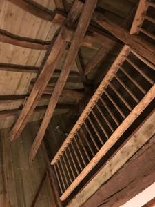 a wooden ceiling in a room with wooden beams at La Grange in Coutouvre