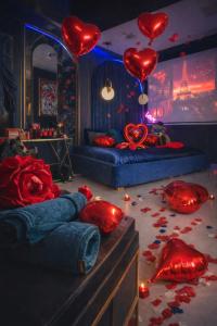 a bedroom with red hearts and red roses on the floor at Love Room 85 avec Jacuzzi & Terrasse Privé in Kortrijk +12 photos