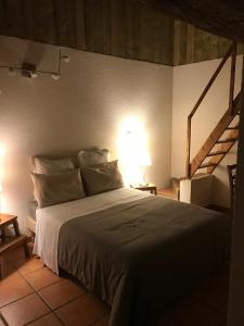 a bedroom with a large bed in a room at La Grange in Coutouvre +4 photos