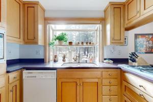 a kitchen with a sink and a window at Dog-Friendly Sunriver condo with deck bikes in Sunriver +31 photos