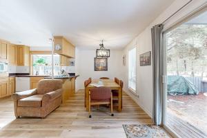 a kitchen and dining room with a table and chairs at Dog-Friendly Sunriver condo with deck bikes in Sunriver
