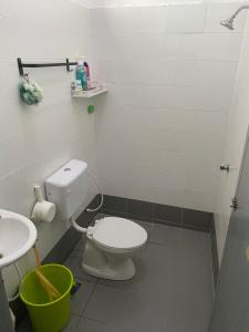 a bathroom with a toilet and a sink at Rumah Homestay in Kangar +30 photos