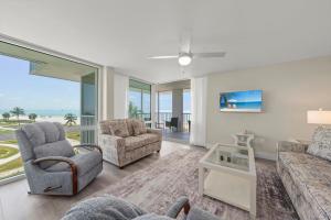a living room with a view of the ocean at Island Beach Club #P3E in Ybel