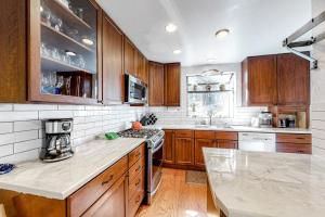 a kitchen with wooden cabinets and a counter top at Ski getaway with amazing mountain views fireplace pool & river path access in Olympic Valley
