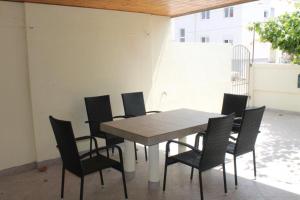 a dining table and chairs on a patio at The Sea House Jaz in Preko +43 photos