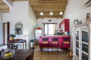 a kitchen with a red island in a room at Cozy Bungalow in the Tropical Gardens of Blue Bay in Blue Bay
