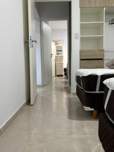 a room with a hallway with a bed and a room with at Añelo Garden Inn in Añelo