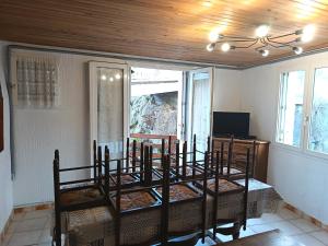a room with a bed with chairs and a table at Au gré du Gave de Pau RDC in Gavarnie