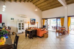 a living room with a couch and a table at Cozy Bungalow in the Tropical Gardens of Blue Bay in Blue Bay