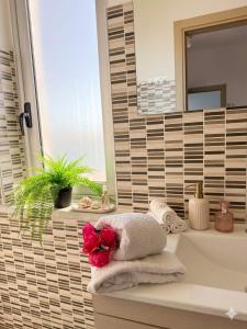 a bathroom with a sink and a towel at Crisvan Home in Capo Rizzuto