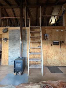 a staircase in a room with a stove at CasaAndina in Malalcahuello