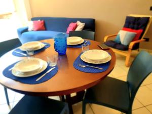 a wooden table with plates and napkins on it at La Finestra sui Tigli in Mandello del Lario