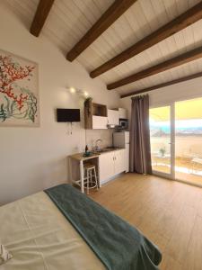 a bedroom with a bed and a kitchen with a table at Antò 2.0 in Castellammare del Golfo +47 photos