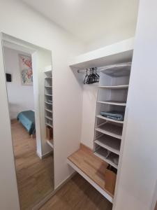 a walk in closet with white walls and wooden floors at Antò 2.0 in Castellammare del Golfo