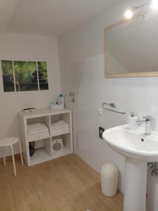 a white bathroom with a sink and a mirror at Apartments and room Maressa Centar in Vodice +34 photos