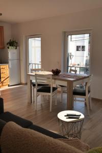 a living room with a table and chairs and a kitchen at Casas Luar da Aldeia - Apartamentos in Odeceixe