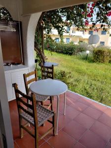 a table and two chairs sitting on a patio at Theano apartment in Argos