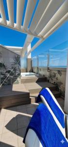 a view of a room with blue sheets on a couch at Club House Hotel in Rimini