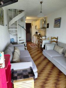 a living room with two couches and a kitchen at Theano apartment in Argos +18 photos