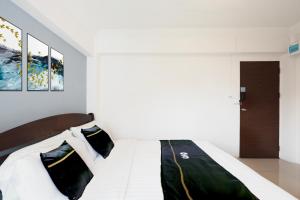 a bedroom with a bed with black and white pillows at Dancenter Rq Suvarnabhumi Airport in Bangkok