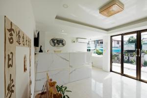 a living room with white walls and a large window at Dancenter Rq Suvarnabhumi Airport in Bangkok