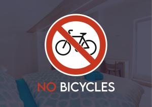 a sign that says no bicycles on a bed at Old Town Rooms Piran in Piran