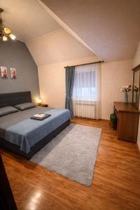 a bedroom with a bed and a window at Отель Ренессанс in Dnipro