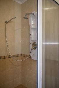 a shower with a hose in a bathroom at Отель Ренессанс in Dnipro