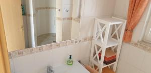a bathroom with a mirror and a sink at Casa Panorama in La Pared +13 photos