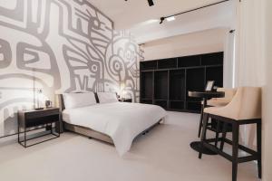 a bedroom with a white bed and a black and white patterned wall at Cocoon Oaxaca City- Curated Stay In Oaxaca Centro in Oaxaca City +39 photos