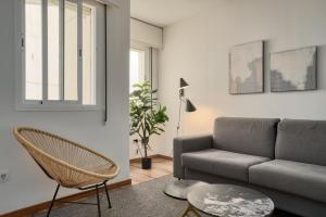 a living room with a couch and a table at MOON Apartments in Seville