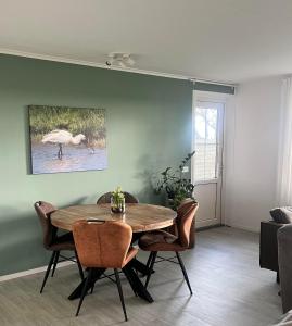 a dining room with a table and chairs at 't Olde Land in Den Burg
