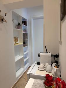 a kitchen with white cabinets and a stove top oven at ValeHouse in Fiumicino