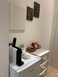 a kitchen counter with a coffee maker and a microwave at ValeHouse in Fiumicino