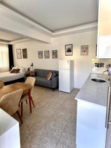a kitchen and a living room with a couch at Eda Sultan Guesthouse - 5 Min Walk to Göynük Beach in Kemer
