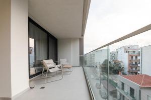 an apartment balcony with a view of a city at KAPA Luxury Living in Volos