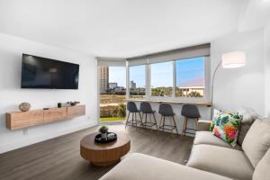 a living room with a couch and a table at Renovated Beach Front Condo TOG 310 in Panama City Beach