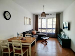 a living room with a table and a couch at Apartamento Stefi in Arrecife