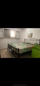 a bedroom with two beds and a window at Villetta maddalena in Lecce