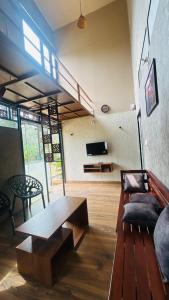 a living room with a wooden table and a couch at The Western Inn in Mananthavady