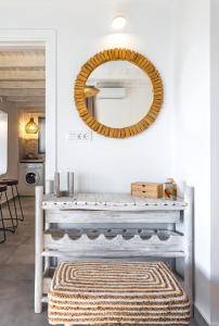 a mirror on a wall above a bench with a rug at Theasea luxury retreat in Vrachonisída touArchangélou +45 photos