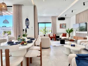 a living room with a table and chairs at Villa Ulysse 4 Bedroom Private Pool in Hammamet